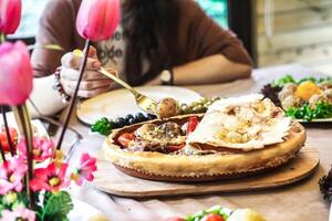 Person Sitting at Table With Plate of Food photo