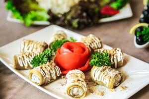 White Plate With Sauce-covered Rolls photo