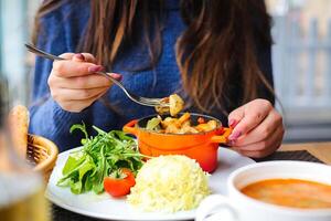 Woman Sitting at Table With Plate of Food photo