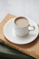 Coffee Cup on Stack of Books photo