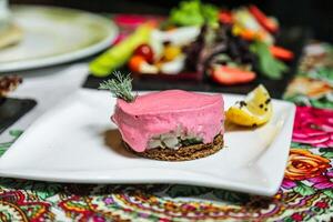 Pink Dessert Topped Plate Among Various Food Dishes photo