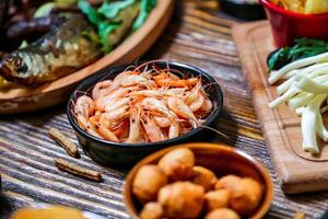 Wooden Table Displaying Assorted Food Bowls photo