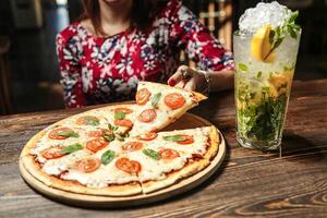 Woman Sitting at Table With Pizza photo