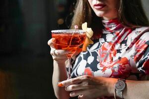 Woman Holding a Drink at a Party photo