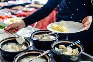 Woman Serving Food From a Buffet Table at a Party photo