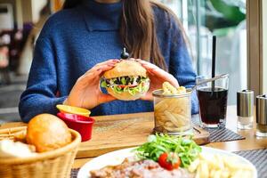 Person Sitting at Table With Plate of Food photo