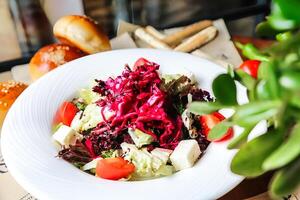 White Bowl Filled With Salad Next to Bread photo