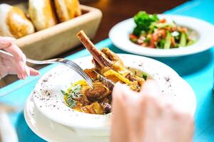 Person Eating Bowl of Food With Fork photo