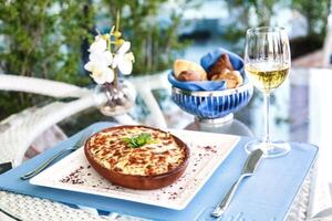 Exquisite Plate of Food and Glass of Wine on Table photo