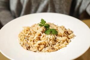 White Plate With Pasta and Parsley Garnish photo