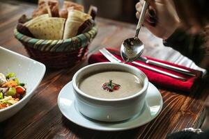 Steaming Bowl of Soup With Spoon photo