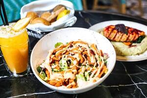 Table With Assorted Plates of Food and Drinks photo