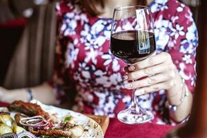 Woman Enjoying a Meal With Wine at a Table photo