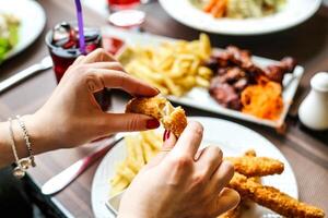 Person Eating Food at Table in a Restaurant photo