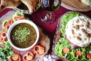 Two Sandwiches and a Bowl of Sauce on a Table photo