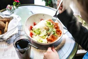 Person Eating Bowl of Food on Table photo