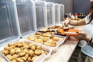 Woman Standing in Front of a Bountiful Food Buffet photo