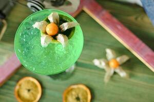 Close Up of Green Drink With Oranges photo