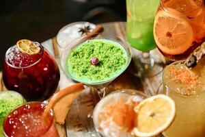 Table With Assorted Glasses Filled With Different Types of Drinks photo