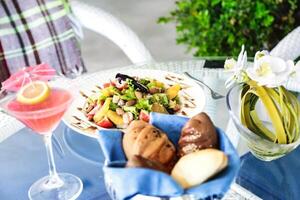 Delicious Plate of Food and Glass of Wine on Table photo