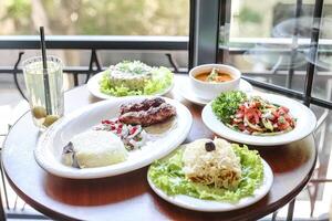 Wooden Table Adorned With Plates of Delicious Food photo