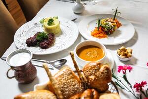 White Table Laden With Plates of Food photo