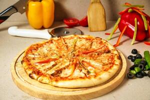 Pizza on Wooden Cutting Board photo