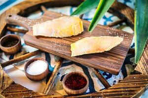 Wooden Tray Topped With Slices of Fish photo