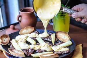 Person Pouring Sauce on a Plate of Food photo