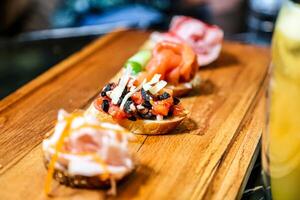 Wooden Cutting Board With Assorted Toppings on Sliced Bread photo