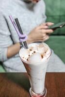 Woman Sitting at Table Using Cell Phone photo