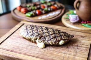 Wooden Cutting Board With Assorted Meat and Fresh Vegetables photo