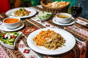 Table With Plates of Food and Bowls of Soup photo