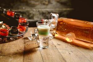 Wooden Table With Glasses Filled With Liquid photo