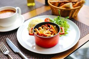 Delicious Plate of Food With a Bowl of Soup on a Table photo