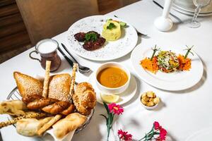 White Table Set With Assorted Plates of Food photo