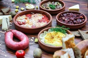 Wooden Table With Assorted Food-Filled Bowls photo
