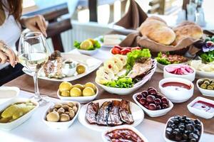 Woman Sitting at Table With Plates of Food photo