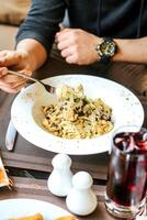 Man Eating Bowl of Food on Table photo