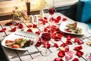 Table With Platters of Food and Glasses of Wine photo