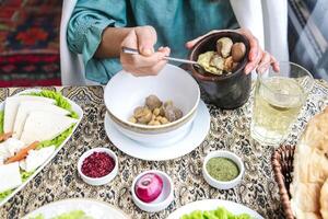 Person Sitting at Table With Bowl of Food photo