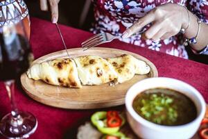 Person Cutting a Piece of Food With Knife and Fork photo