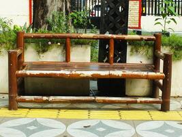 wooden bamboo bench as public facility on sidewalk for background design photo