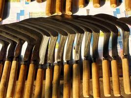 Various shapes of knives are sold in the market. Some of them is use by farmer on the field. This product handmane by blacksmith photo