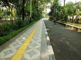 Surakarta, April 11 2024, quiet streets with lush trees and other public facilities around Manahan Stadium. photo