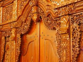 The beauty art of a traditional javanese teak carved door. People called it a gebyok door. photo