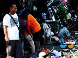 Surakarta City, Central Java, Indonesia, April 15, 2024. Notoharjo Market. The flea market is located on the outskirts of town, always busy with visitors in the morning. Buying and selling used goods photo