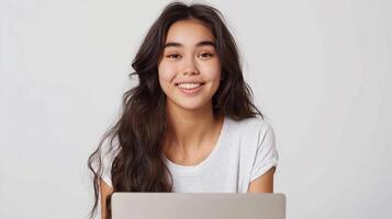 Young smiling pretty woman worker sitting and looking at laptop screen during teleconference, online lecture, isolated on white background photo