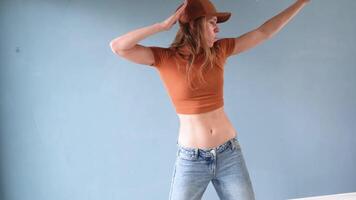 woman dancing hip hop or modern dance in blue studio, warming up video