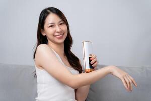 A beautiful woman is epilating and removing hair using an IPL laser hair removal epilator device. photo